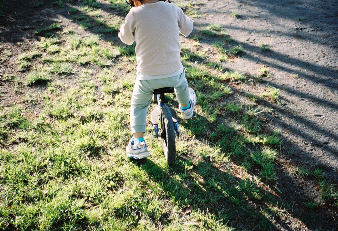 バランスバイクで駆けていく、子どもの後ろ姿